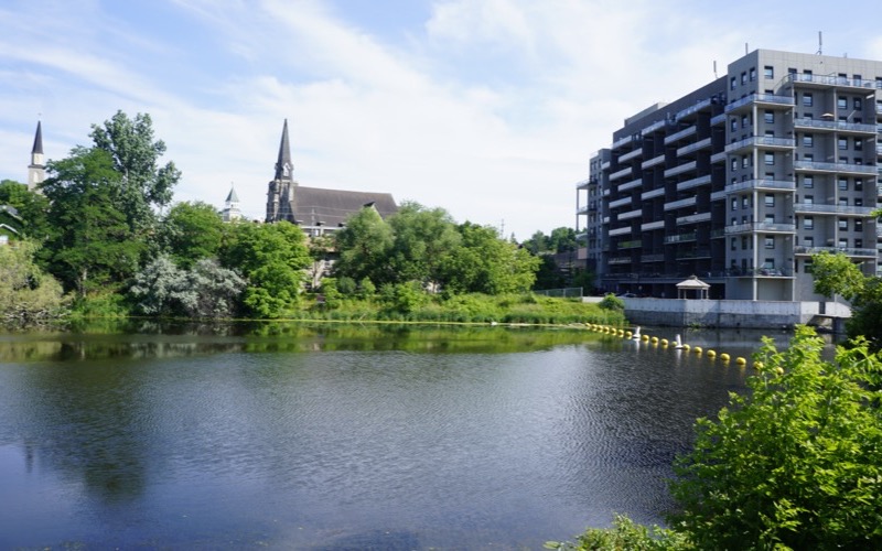 Hespeler Mill Pond with church spires and trees along the shore